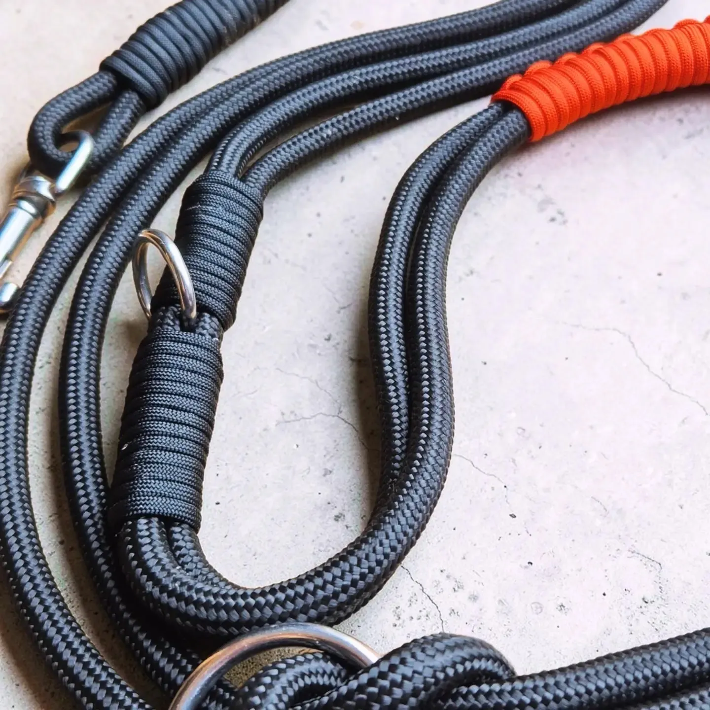 Detail of black rope lead splices and stainless steel rings