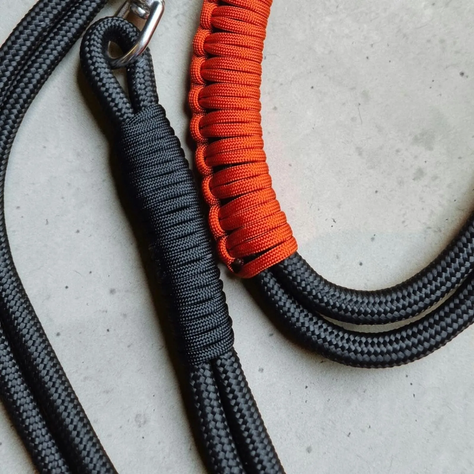 Black rope lead with an orange braided handle whipping