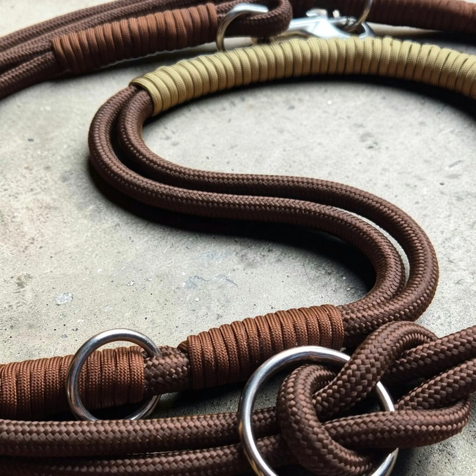 Close-up of a brown rope lead with sand whipping and stainless steel rings