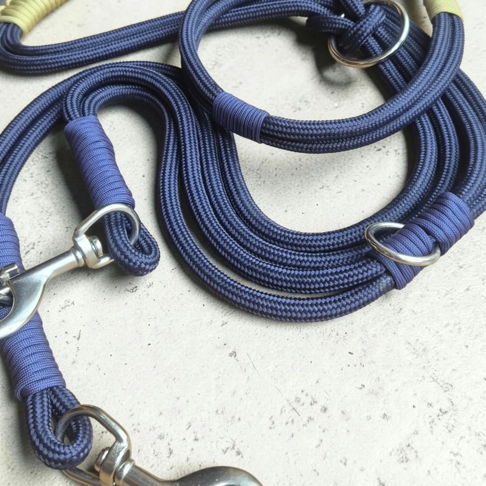 Detail of a navy rope lead handle with beige whipping